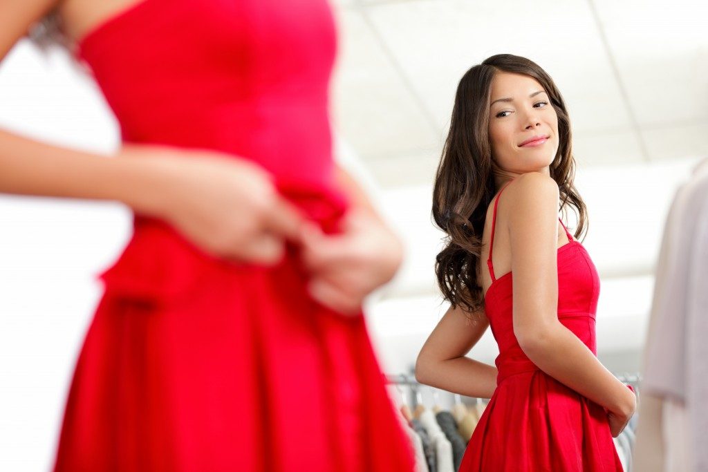 woman fitting a red dress