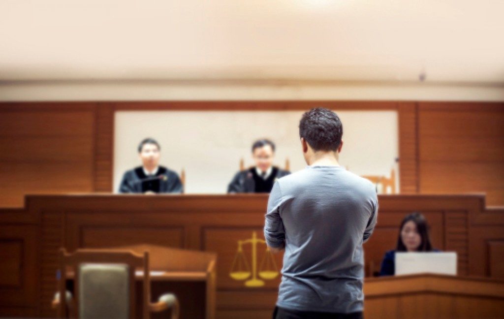 man standing inside a courtroom