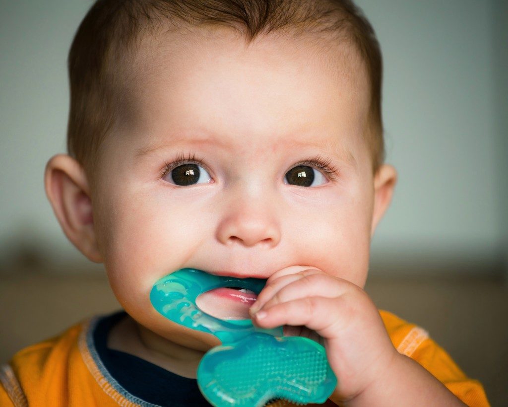 baby playing with teething toy