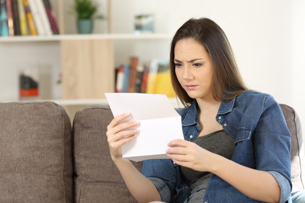 woman reading her denied business loan application
