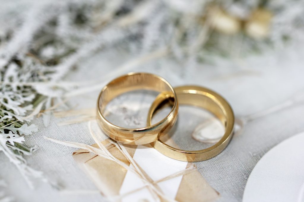 a pair of gold wedding rings